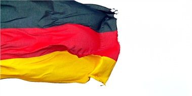 weathered germany flag on wind
