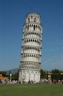 people on lawn at leaning tower, italy, pisa