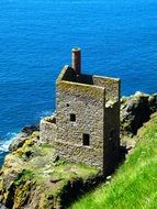 ruined engine house of botallack mine on cliff at sea, uk, england, cornwall, st just