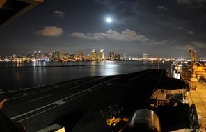 distant view of city at full moon night from harbour, usa, california, san diego