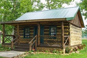 log cabin among trees at summer