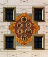 coat of arms on the building among the windows