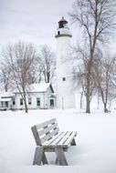 Bench near a lighthouse in winter