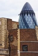 Gherkin tower at aged stone building, uk, england, London