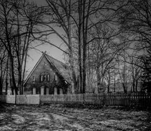 old house in fenced garden at winter