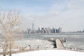 winter city skyline at frozen river, usa, nyc