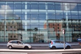 speed limit sign in front of a glass building
