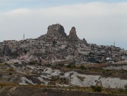 town at castle rock on landscape, turkey, cappadocia, uchisar