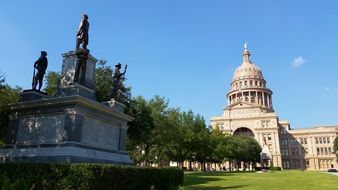 three-story Sunset Red Texas Granite capitol building in park, usa, texas, austin