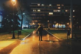 person in urban park at night