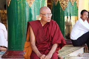 Sitting monk in buddhist temple