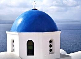 blue dome of orthodox church in seascape, greece, santorini