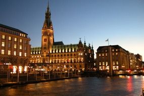 illuminated town hall in city at evening sky, germany, hamburg