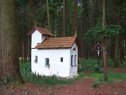 small old white chapel in forest, germany