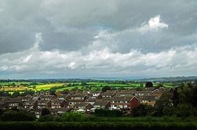 village and fields in scenic countryside before rain, uk, england, harrogate