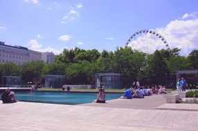 people resting at pool in city park at summer, hungary, budapest