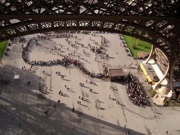 long queue of tourists on square at eiffel tower, france, paris