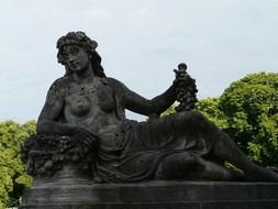 young woman with grapes, aged sculpture