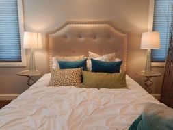 bedroom with pillows on bed at head board