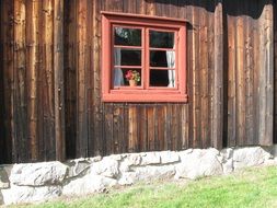 pink window in wooden wall of finnish style house