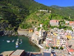 top view of old town on mountain side at bay, italy, vernazza