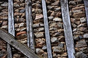 old stone wall with wooden bars, spain, salamanca