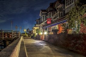 night light seaside waterfront road buildings