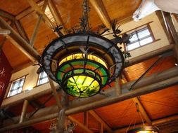 colorful stained glass light at wooden ceiling