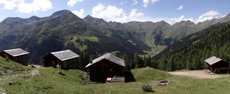 wooden buildings on mountain side at summer, austria, east tyrol