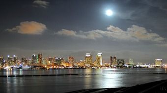 colorful lights of city at bay in full moon night, usa, california, san diego