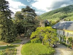 two-storey mansion at driveway in summer countryside, france