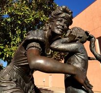 happy mother with daughter, bronze sculpture outdoor