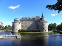 aged moated castle at summer, sweden, örebro