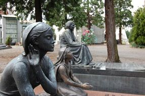 praying girls, sculptures on cemetery, italy, milan