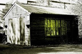 monochrome picture of old wooden building with gable roof