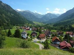 village in valley among forested mountains at summer, germany, hinterstein