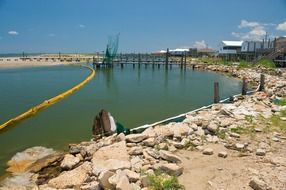oil spill protection barricade on sea at shoreline