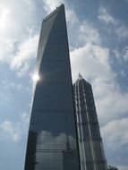 modern skyscraper in the background of white clouds in shanghai