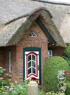 picturesque entrance to traditional house with reed roof, germany, mecklenburg