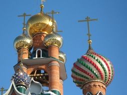 domes of orthodox church with golden crosses at blue sky, russia, voronezh