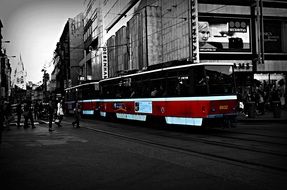 people at red tram on street in city