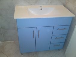 bathroom cabinet with sink at tile wall