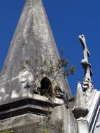 aged monument with cross on cemetery, argentina, buenos aires