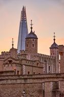 the shard building behind tower of london palace at sunset, uk, england