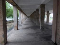 perspective of long passage with pillars under concrete building, sri lanka