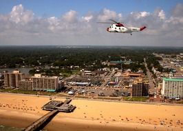 helicopter in sky above beach at city buildings, usa, virginia