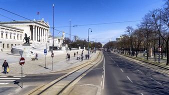 people walking on street at Austrian parliament building, austria, vienna