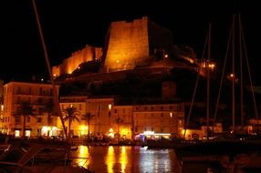 corsican night, old town and fortress at water, france