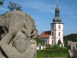 modern stone sculpture in front of church