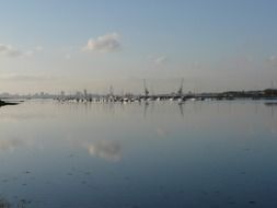 distant view of harbor and city at calm water, uk, portsmouth
